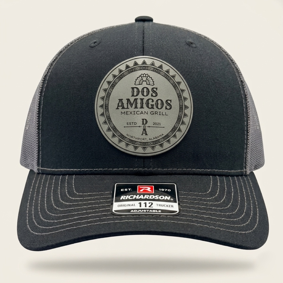 Charcoal Richardson trucker cap with engraved Dos Amigos Mexican Grill logo patch