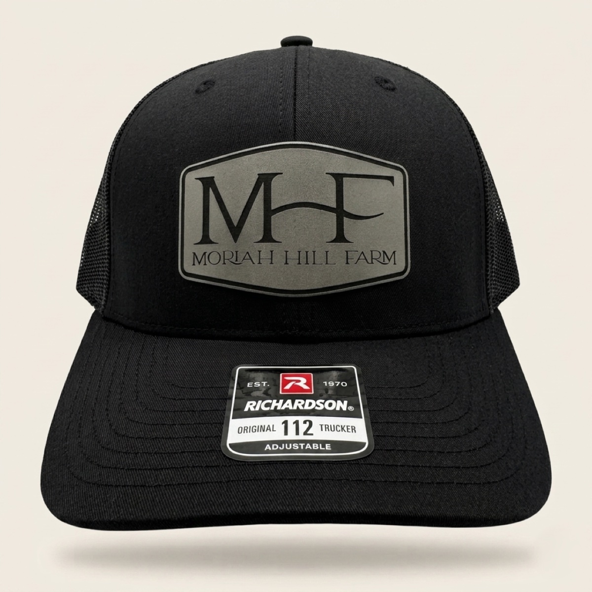 Black Richardson trucker cap with engraved Moriah Hill Farm MHF logo patch